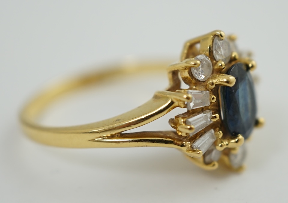 A modern 18ct gold, sapphire and diamond oval cluster ring